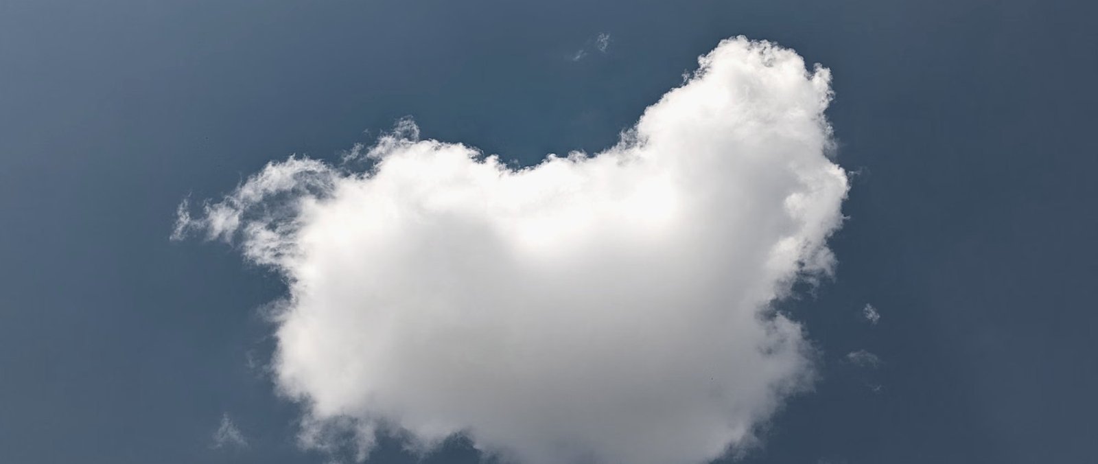 A heart shaped cloud in a clear sky